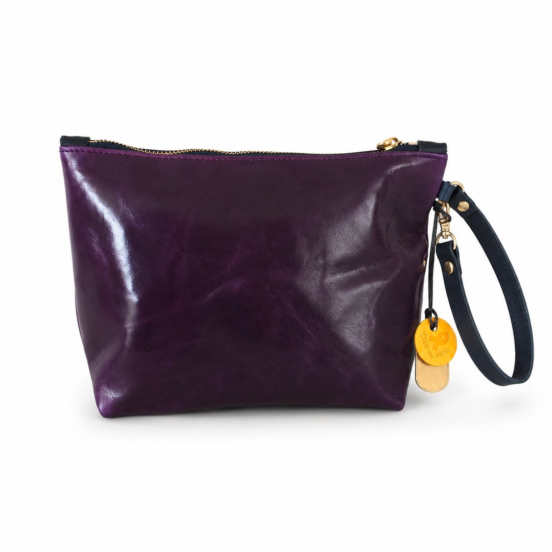 A purple leather wristlet pouch with a black wrist strap, gold zipper, and two round yellow charms, shown on a white background.