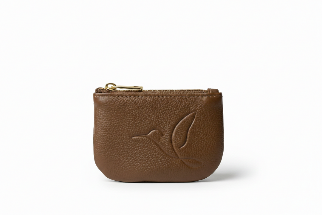 Brown leather pouch with a bird emblem on a white background