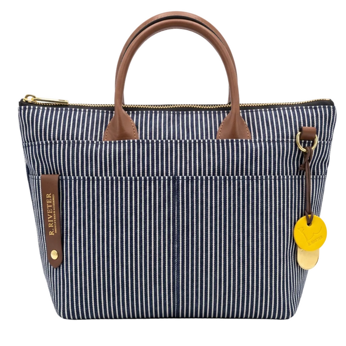 Striped handbag with brown handles and accents on a white background