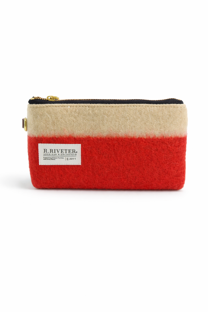Two-tone red and beige pouch with a visible brand label on a white background