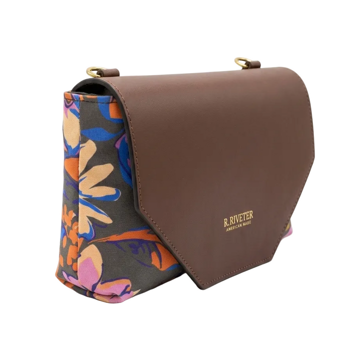 Brown handbag with colorful floral pattern on a white background