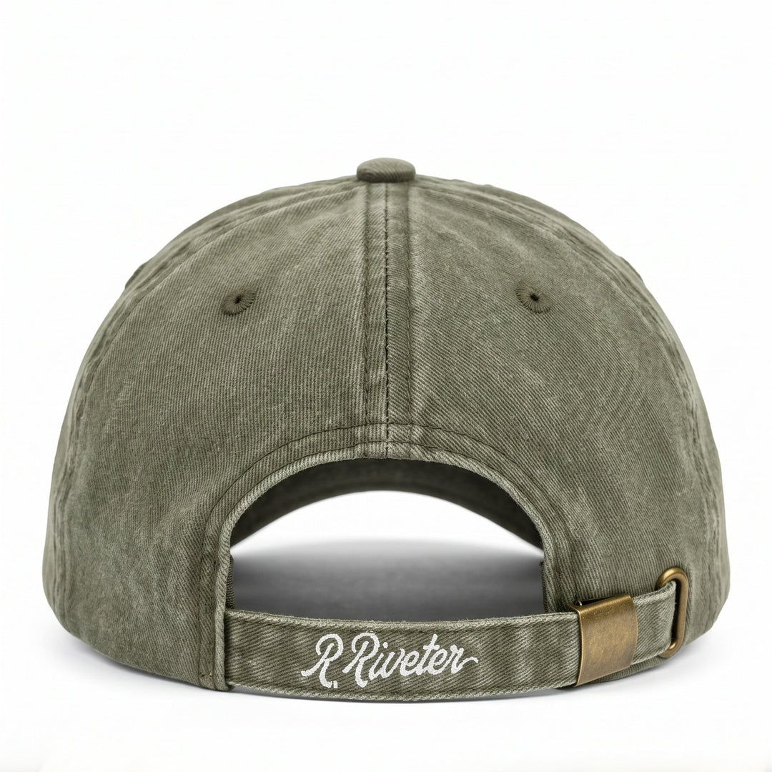 Riveter brand baseball cap in a washed olive green color, showing the back of the cap with an adjustable strap and a small gold-tone metal accent.