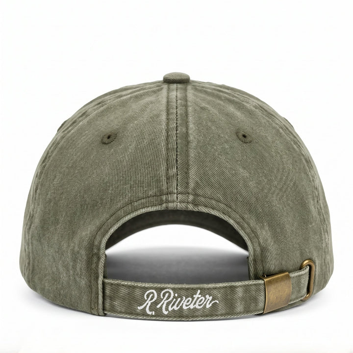 Riveter brand baseball cap in a washed olive green color, showing the back of the cap with an adjustable strap and a small gold-tone metal accent.