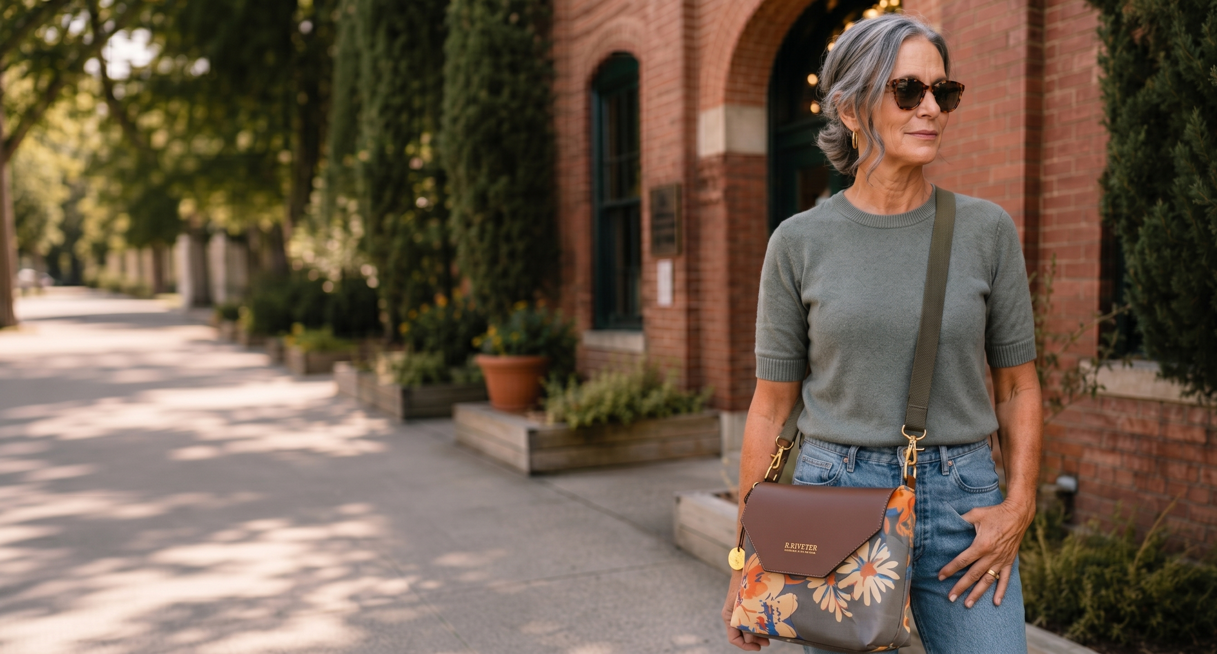 Woman holding a floral-patterned handbag in an outdoor setting