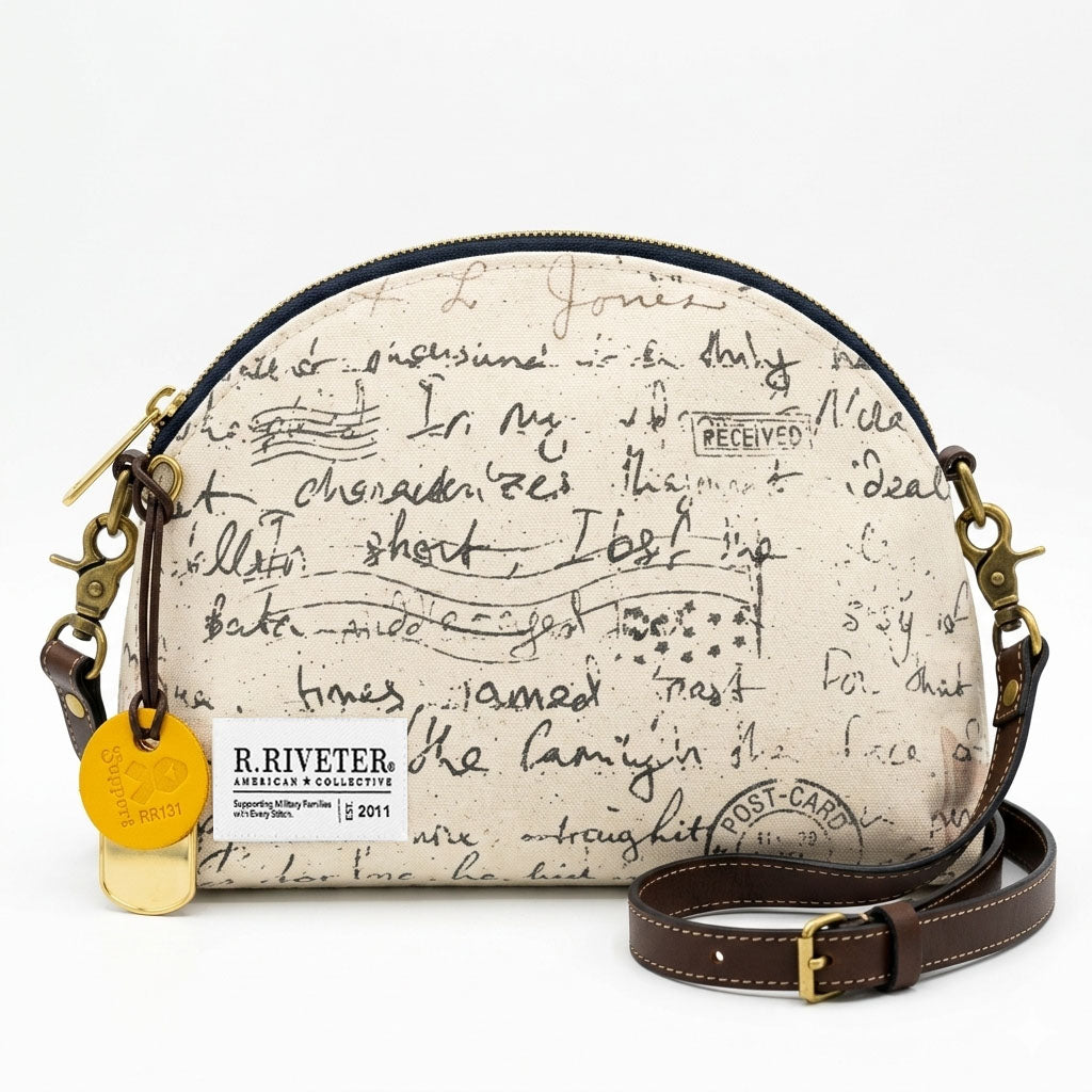 Round handbag with script design and visible brand tag on a white background