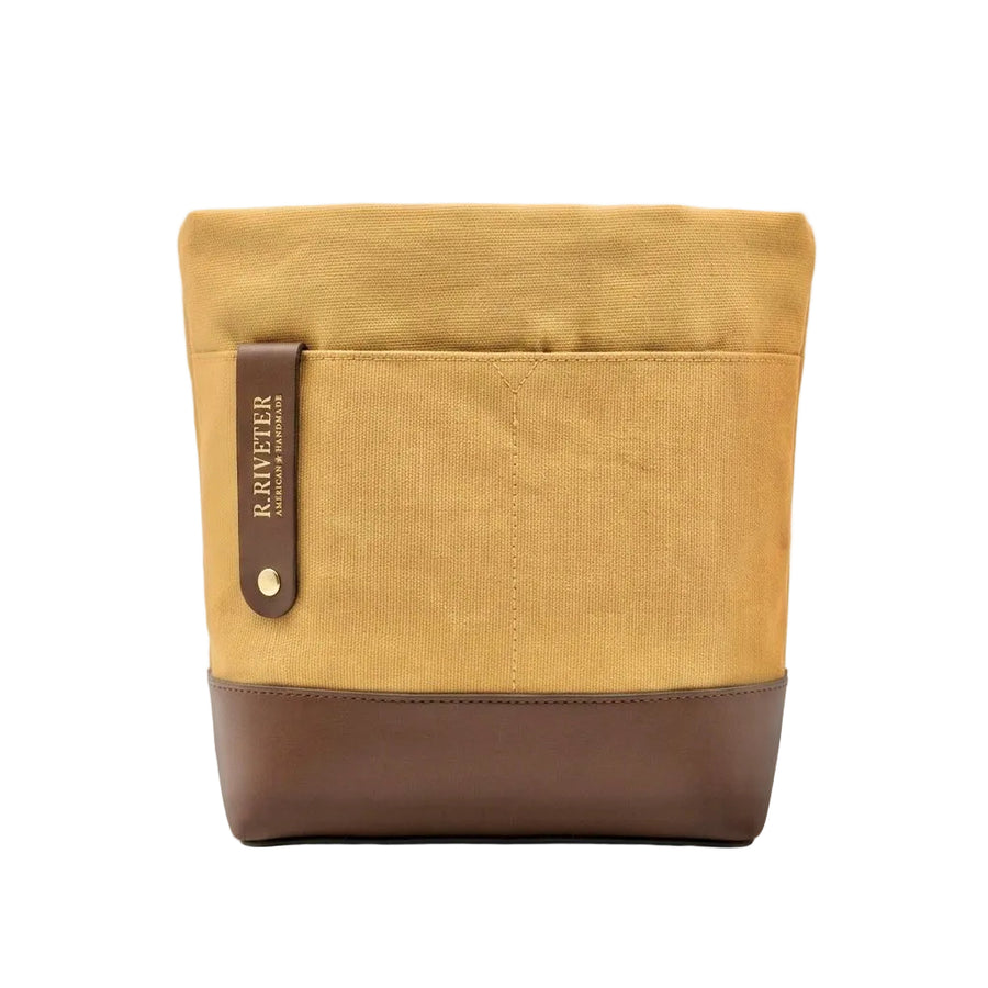 A canvas bucket bag in mustard yellow and brown, featuring a brown leather strap with the brand name 'R. RAWETER' printed vertically, set against a plain white background.