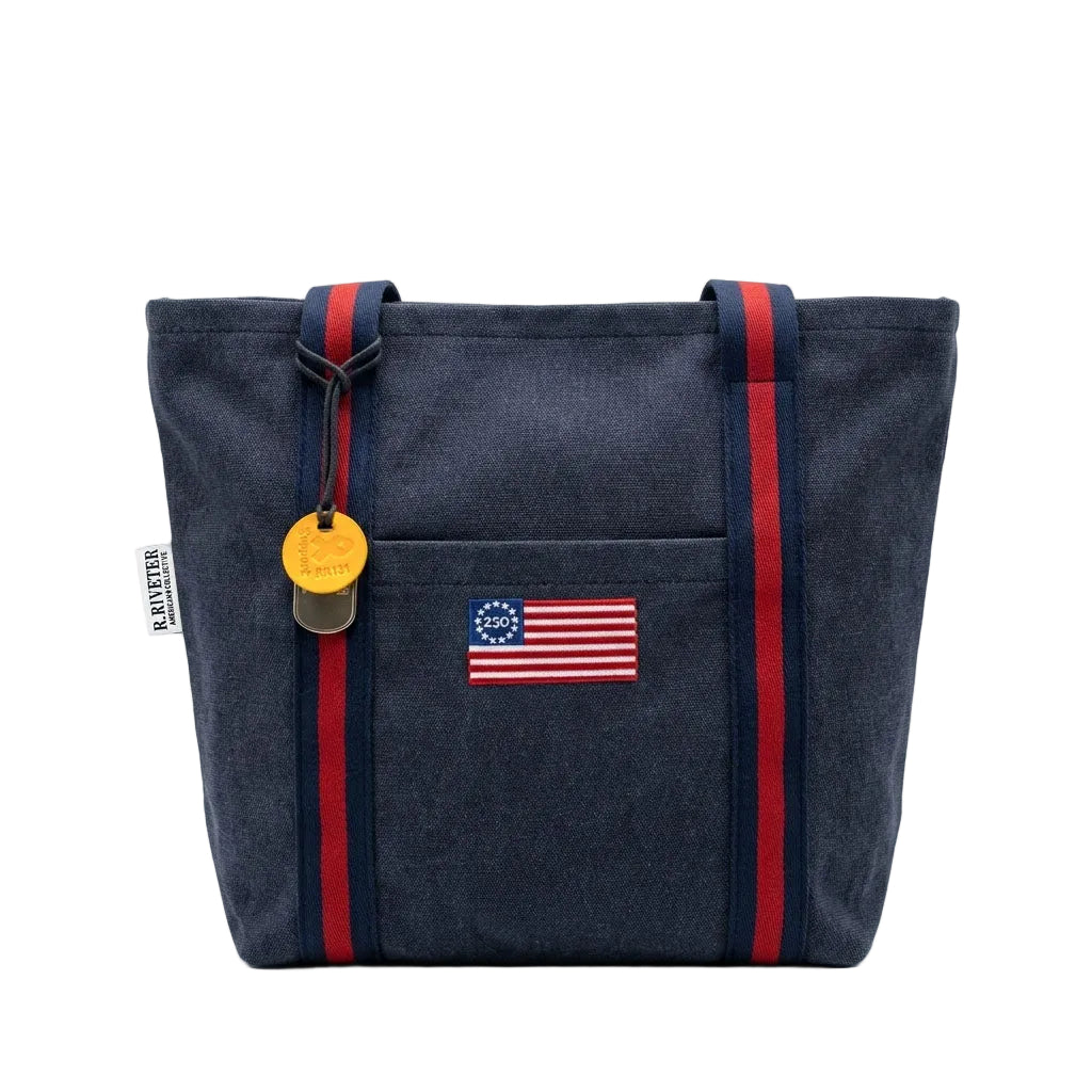 Navy tote bag with American flag patch and red straps on a white background