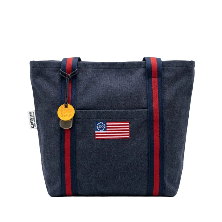 Navy tote bag with American flag patch and red straps on a white background