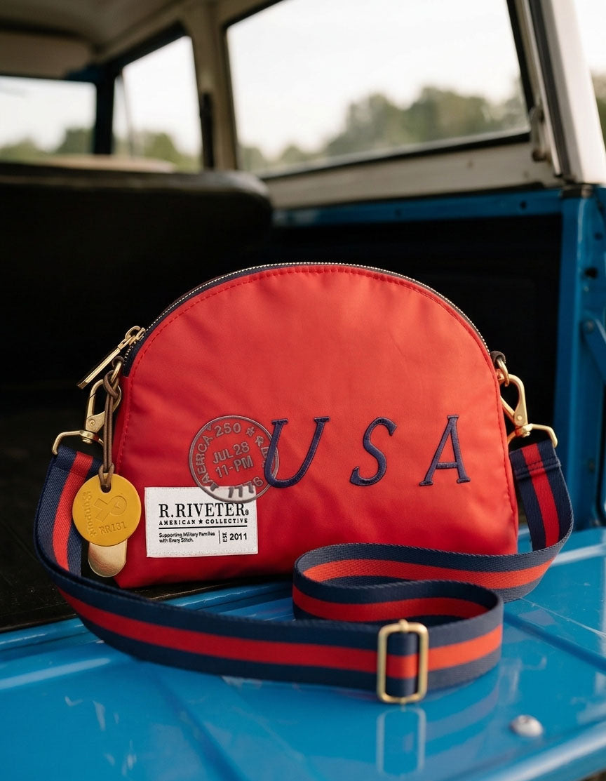 Red handbag with 'USA' embroidery on a blue vehicle