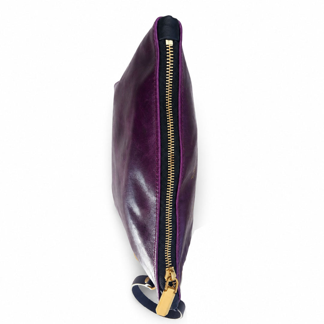 A dark purple leather clutch bag with a gold zipper and a small dark blue wristlet strap, shown from a side profile view on a white background.