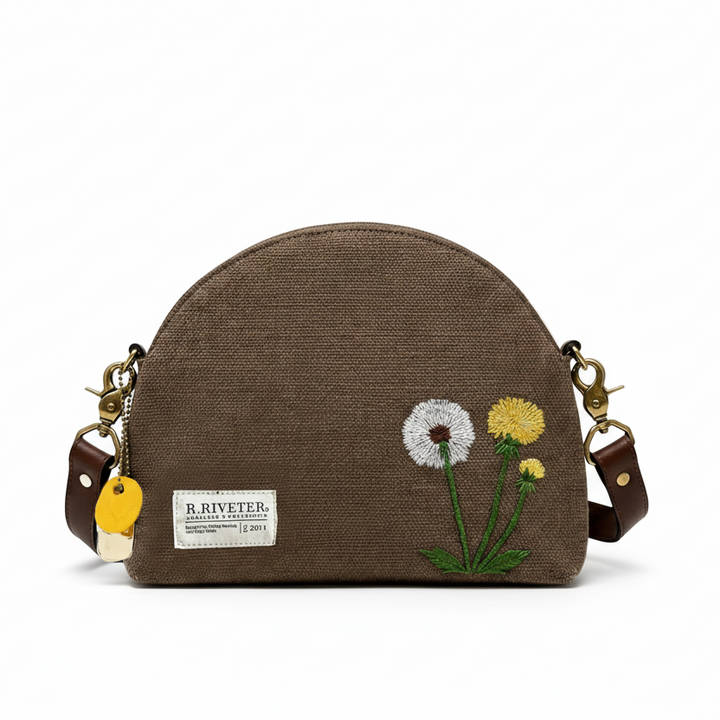 Brown handbag with embroidered flowers and R. Riveter label on a white background