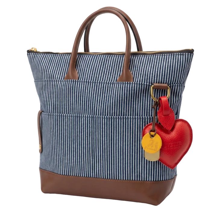 Blue striped tote bag with brown accents and a red heart-shaped tag on a white background