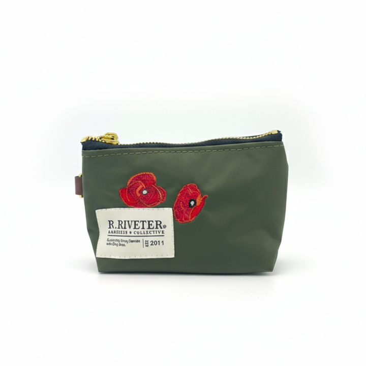Green pouch with poppy designs and Riveter branding on a white background