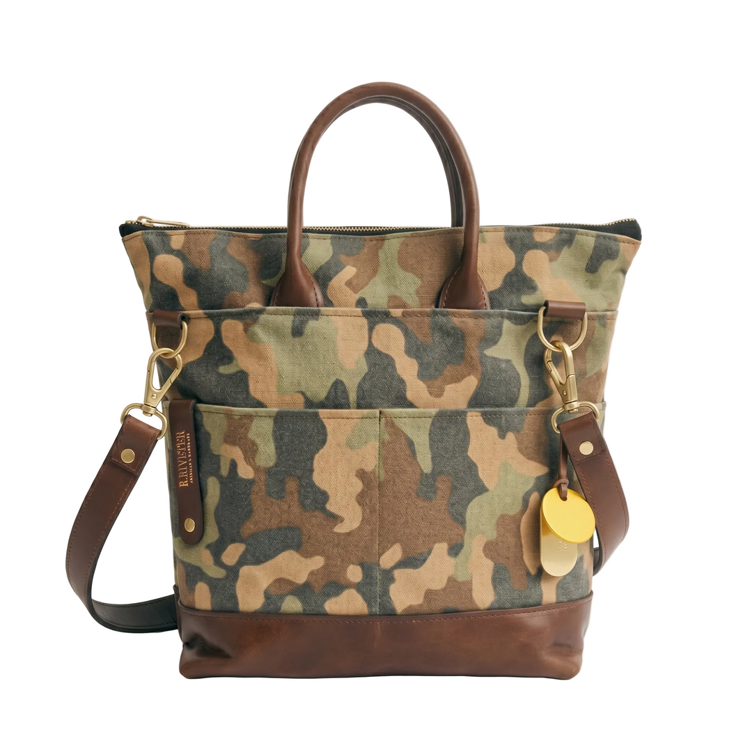 Camouflage-patterned handbag with brown leather accents on a white background