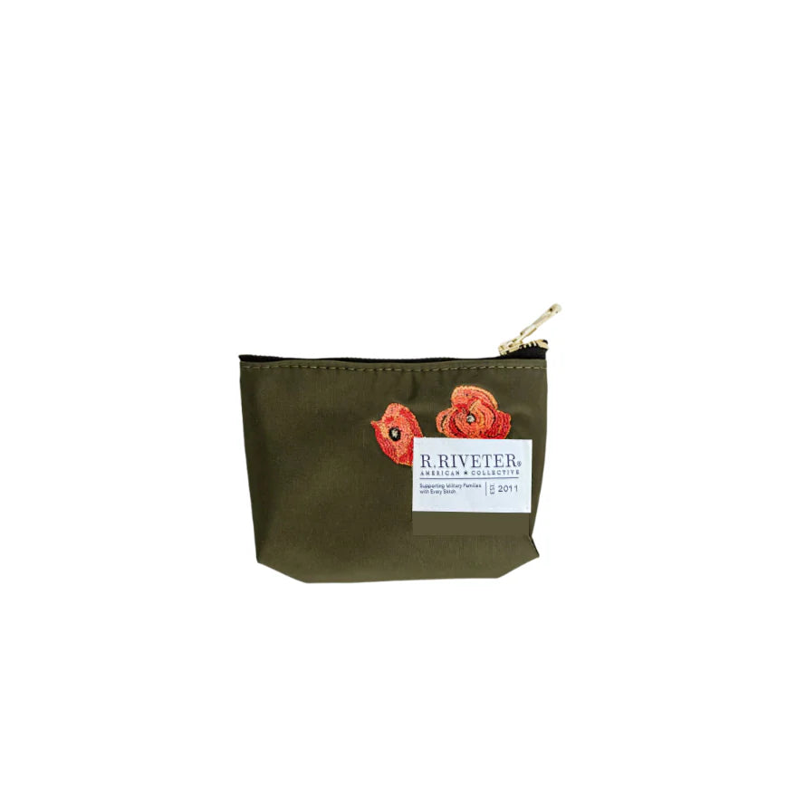 An olive green canvas zippered pouch featuring two embroidered red poppies and a white brand label that reads 'R. RIVETER'.