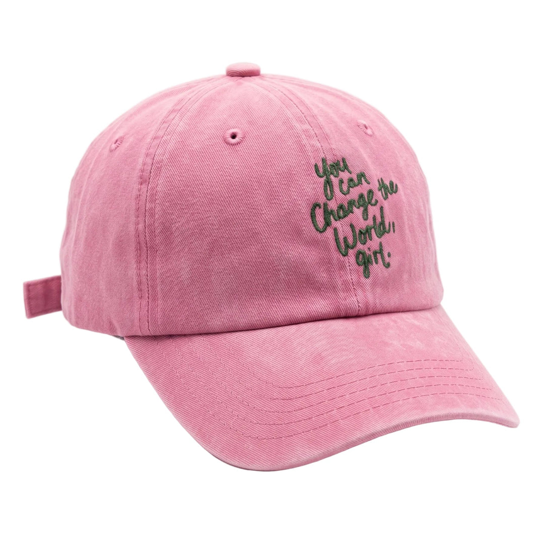 A pink washed cotton baseball cap with black embroidered text on the front that reads 'You Can Change the World, Girl!'.