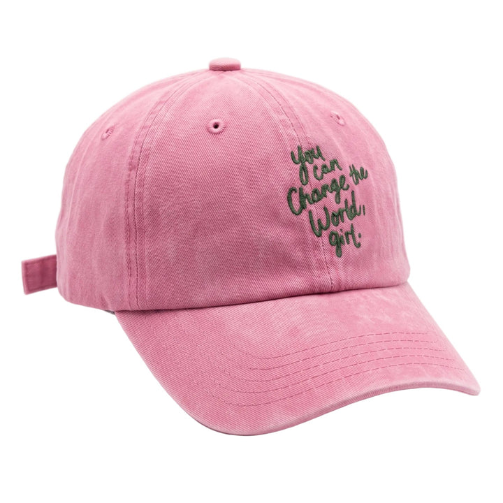 A pink washed cotton baseball cap with black embroidered text on the front that reads 'You Can Change the World, Girl!'.