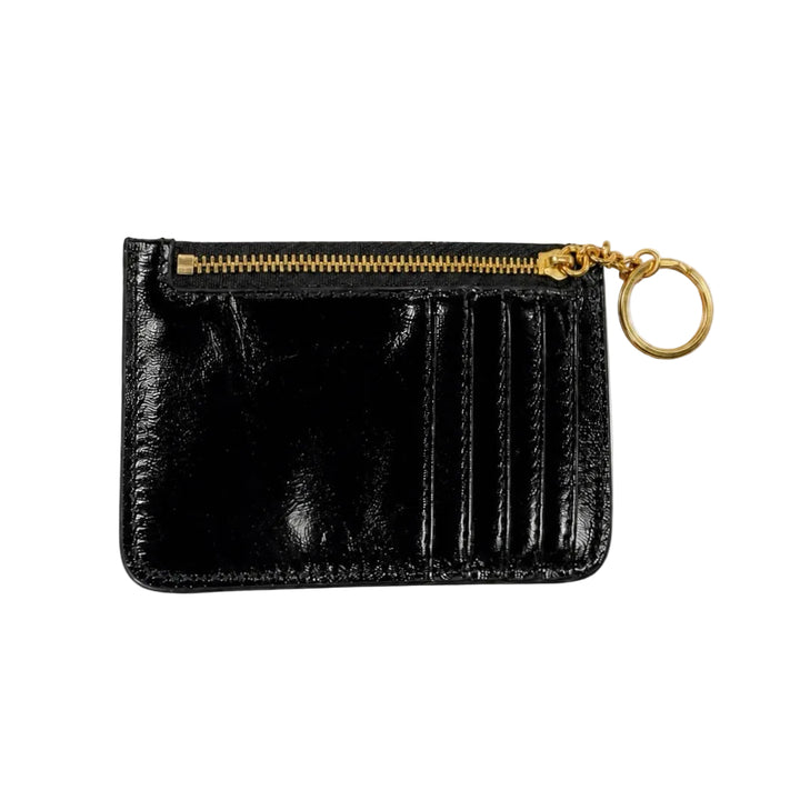 A black patent leather card holder with a gold zipper, gold keychain ring, and gold hardware, shown on a plain white background.