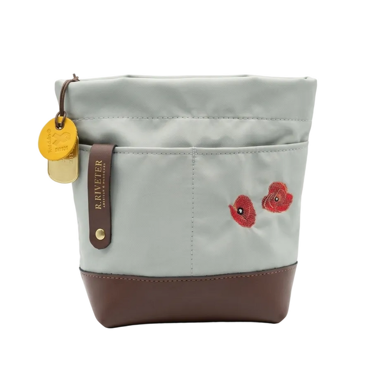 Light gray bag with brown bottom and red floral embroidery on a white background