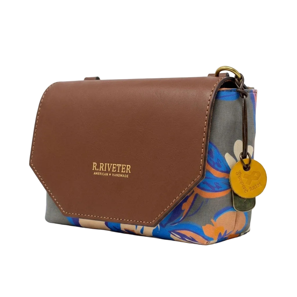 Brown leather handbag with floral pattern on a white background, featuring the brand 'R. Riveter'.